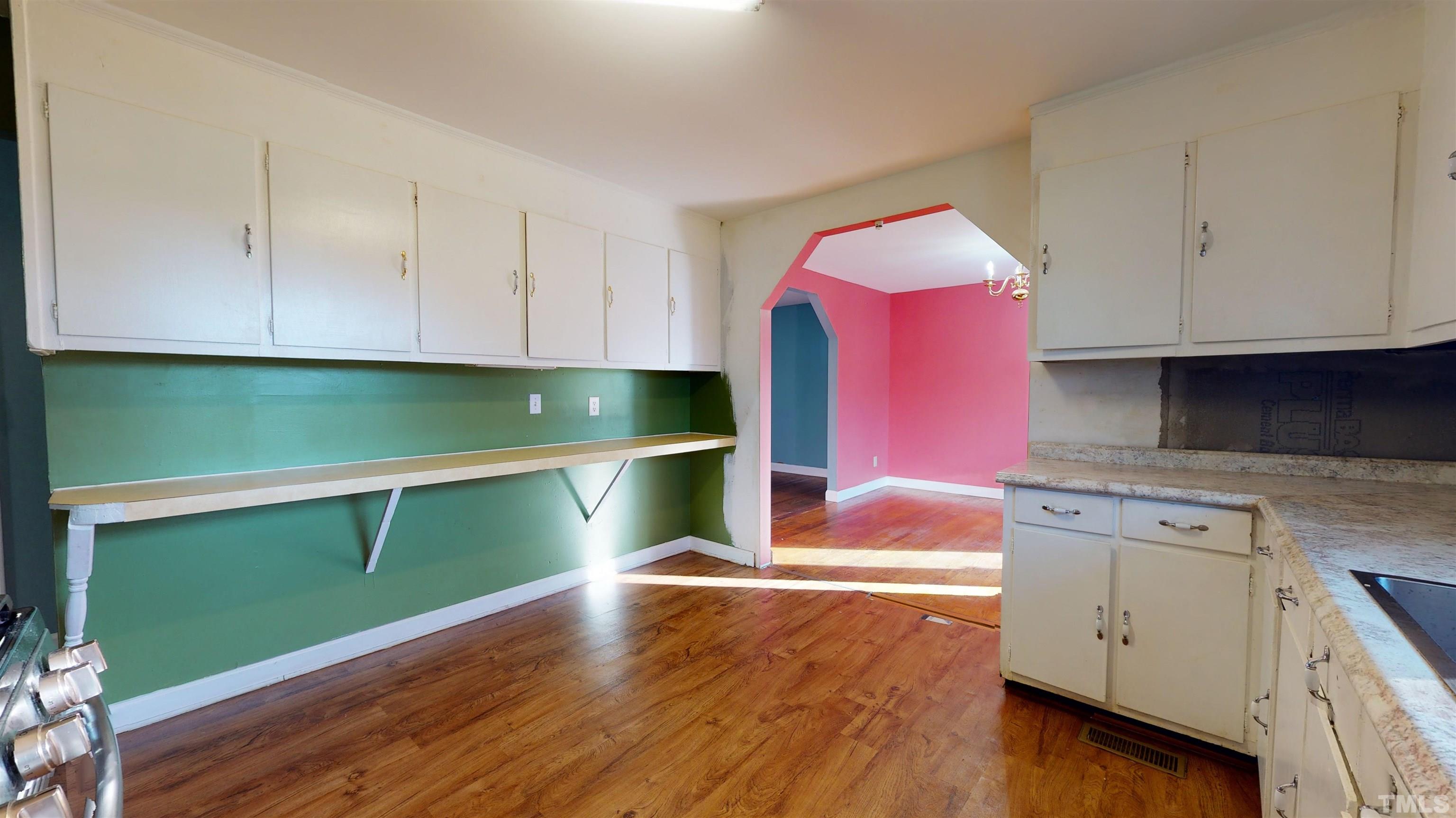 1306 Old Durham Road Roxboro, NC 27573 - Photo 19 of 28 a kitchen with cabinets and a wooden floor