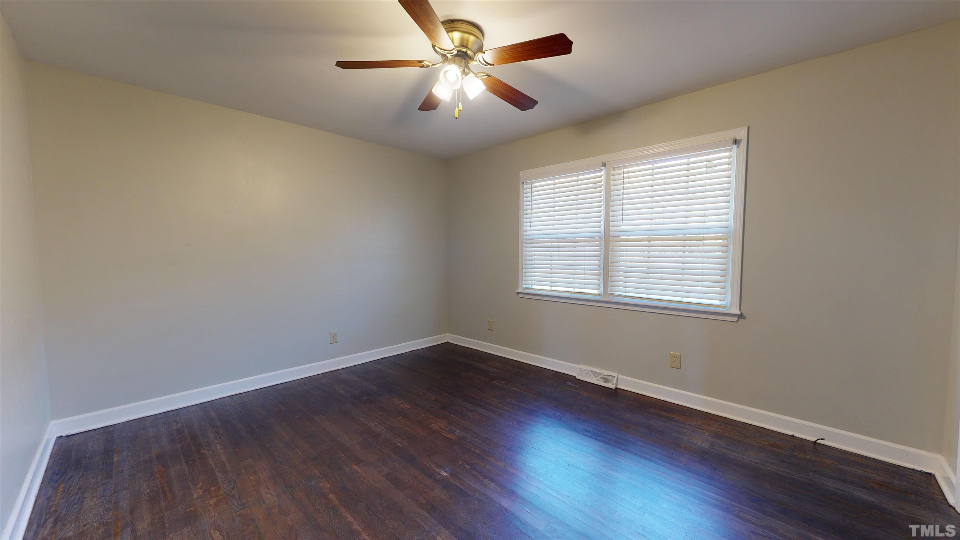 1306 Old Durham Road Roxboro, NC 27573 - Photo 20 of 28 a view of a room with wooden floor and windows
