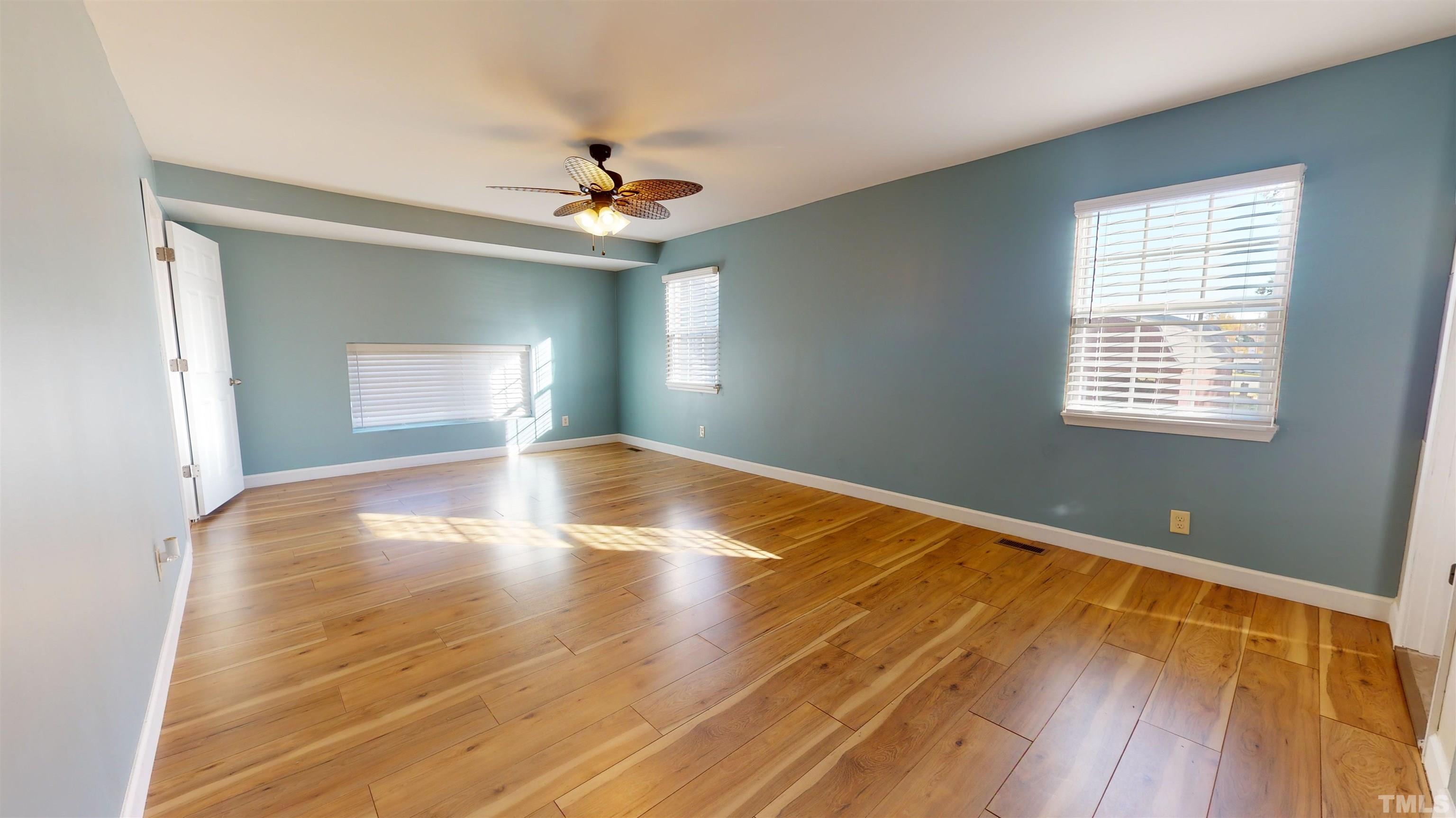 1306 Old Durham Road Roxboro, NC 27573 - Photo 3 of 28 a view of empty room with wooden floor and fan