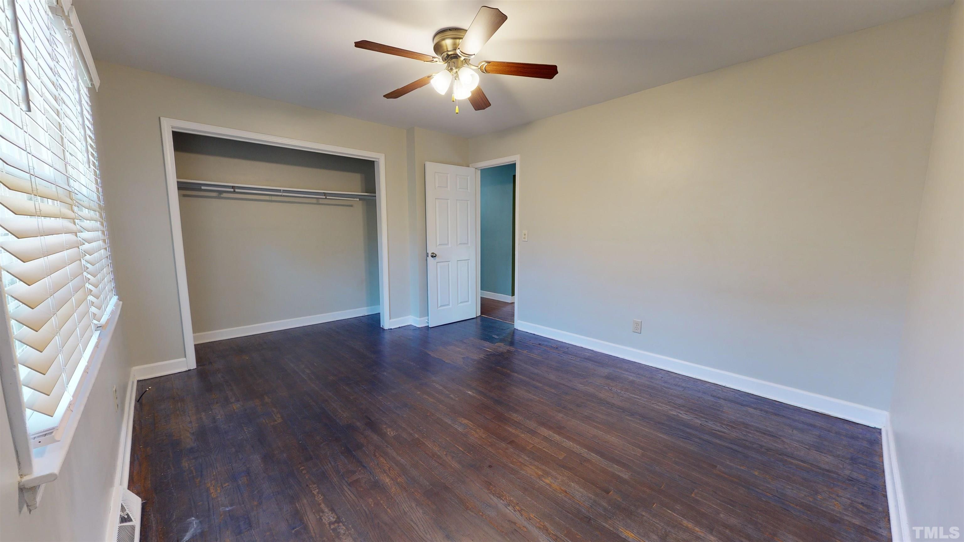1306 Old Durham Road Roxboro, NC 27573 - Photo 21 of 28 a view of empty room with wooden floor and fan