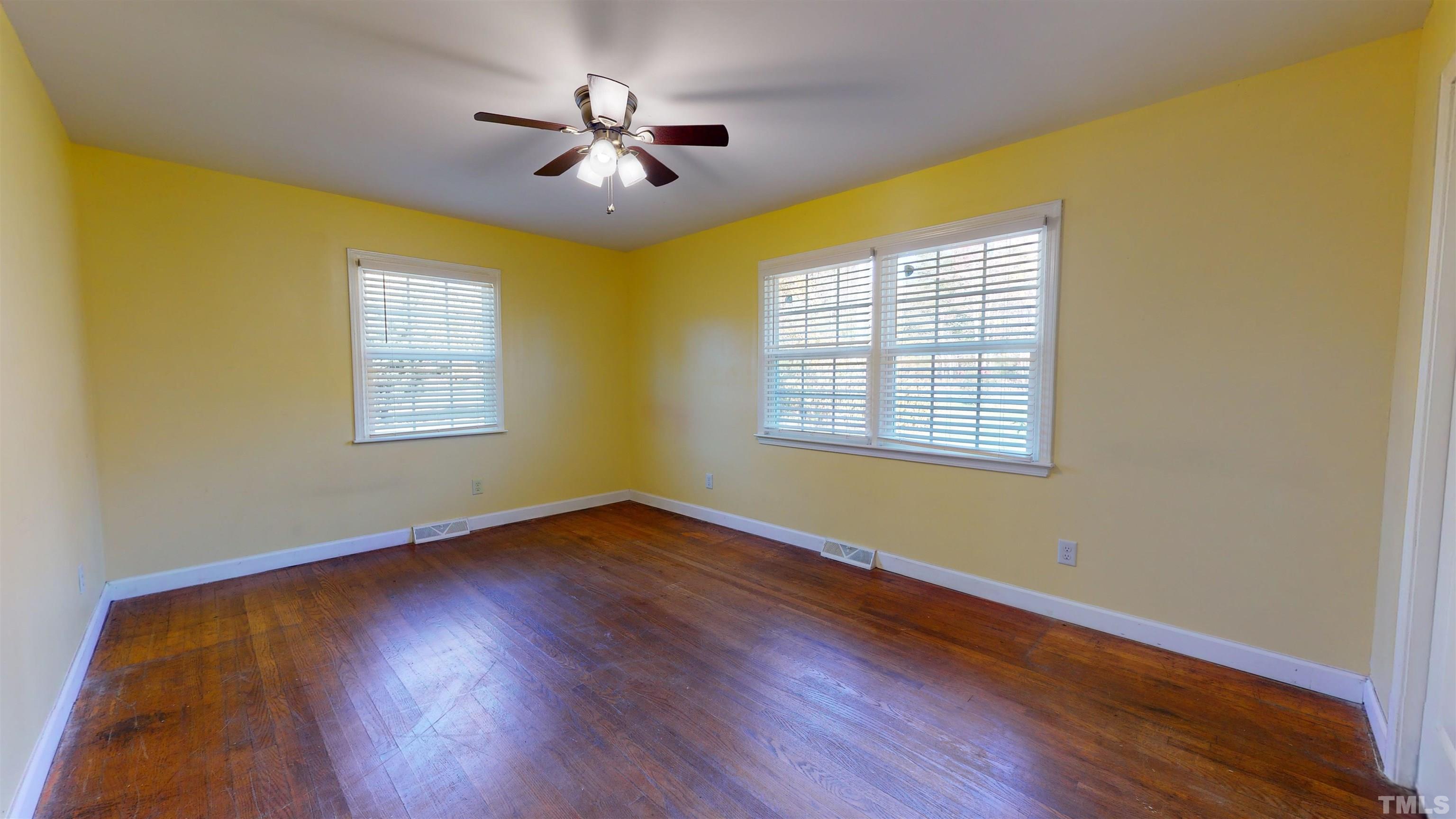 1306 Old Durham Road Roxboro, NC 27573 - Photo 23 of 28 a view of an empty room with wooden floor and a window