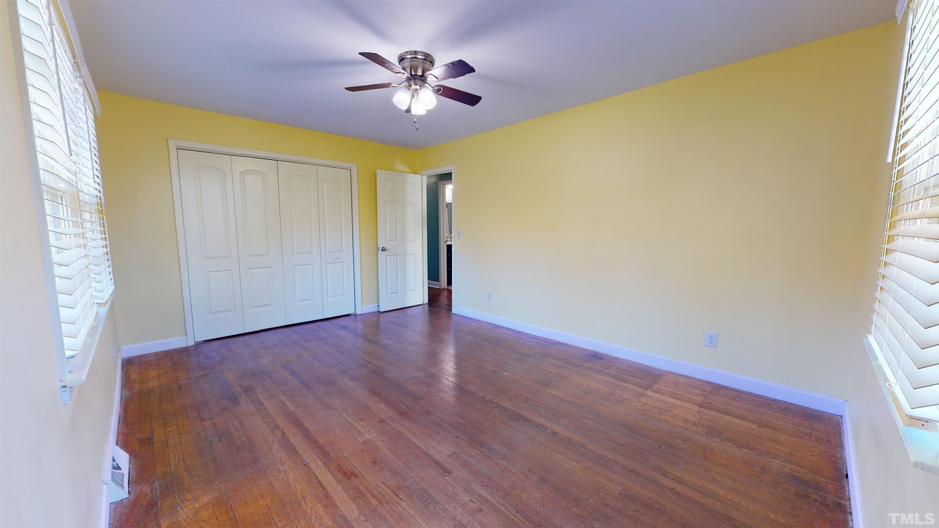 1306 Old Durham Road Roxboro, NC 27573 - Photo 24 of 28 a view of an empty room with a window and wooden floor