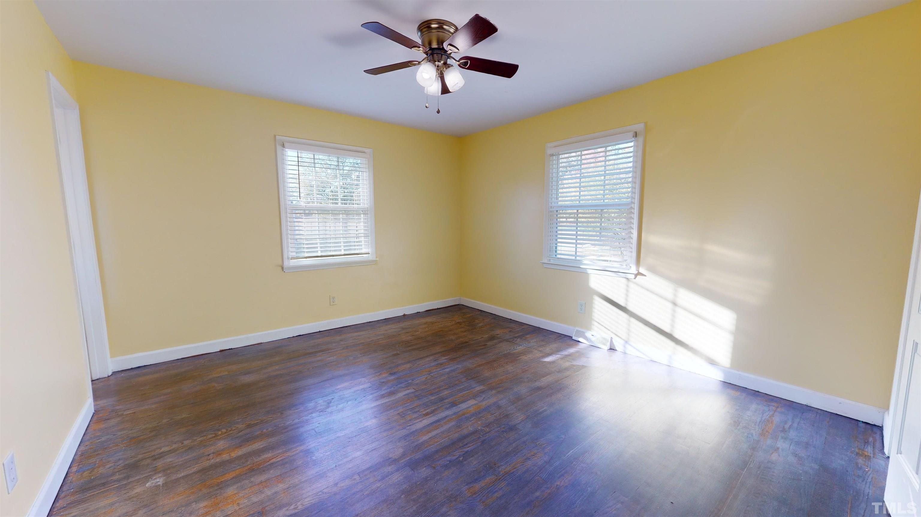 1306 Old Durham Road Roxboro, NC 27573 - Photo 26 of 28 a view of empty room with wooden floor and fan