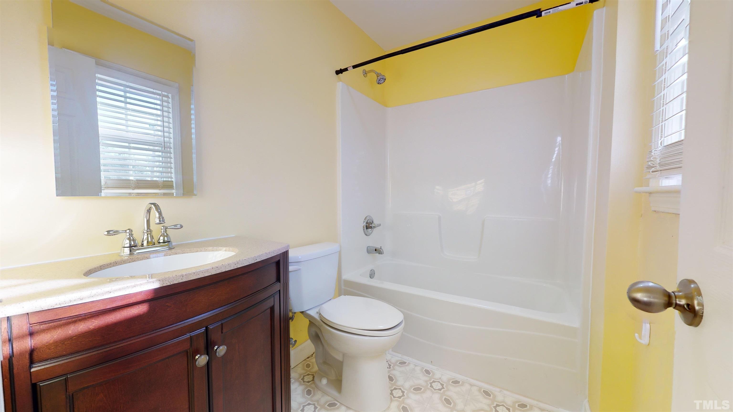 1306 Old Durham Road Roxboro, NC 27573 - Photo 27 of 28 a bathroom with a granite countertop sink toilet and shower
