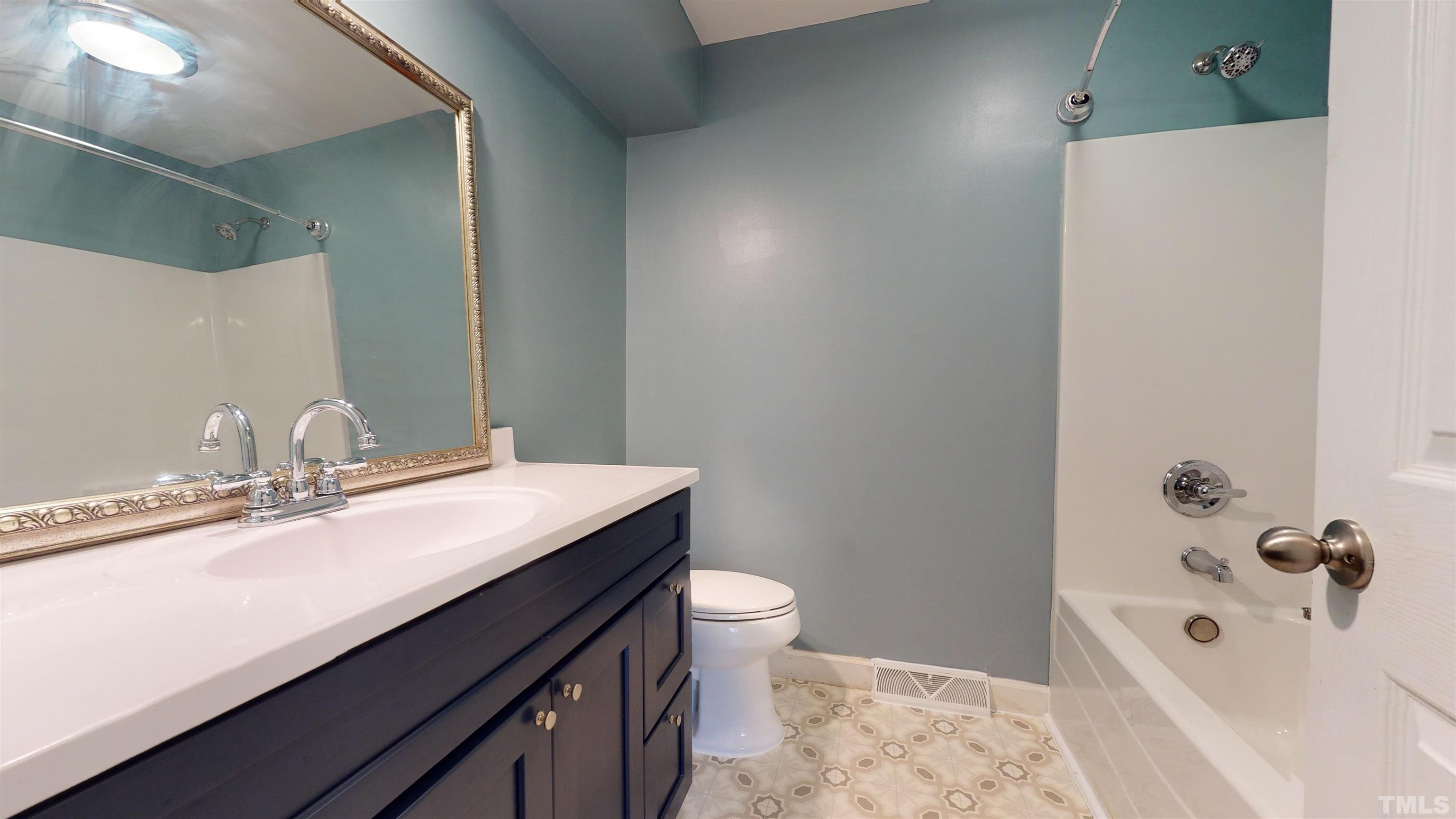 1306 Old Durham Road Roxboro, NC 27573 - Photo 28 of 28 a bathroom with a sink a toilet and shower