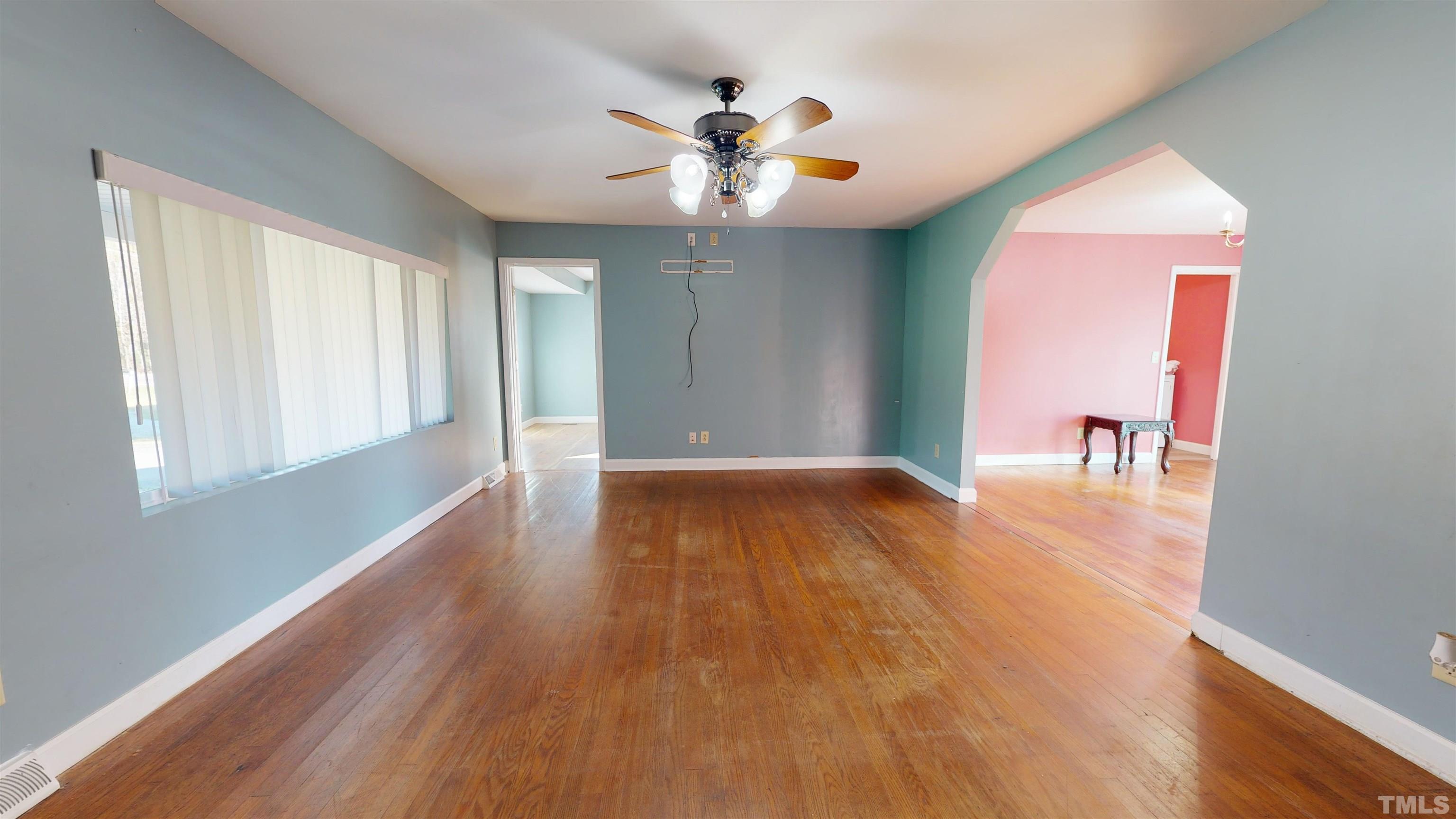 1306 Old Durham Road Roxboro, NC 27573 - Photo 9 of 28 a view of an empty room with window and wooden floor
