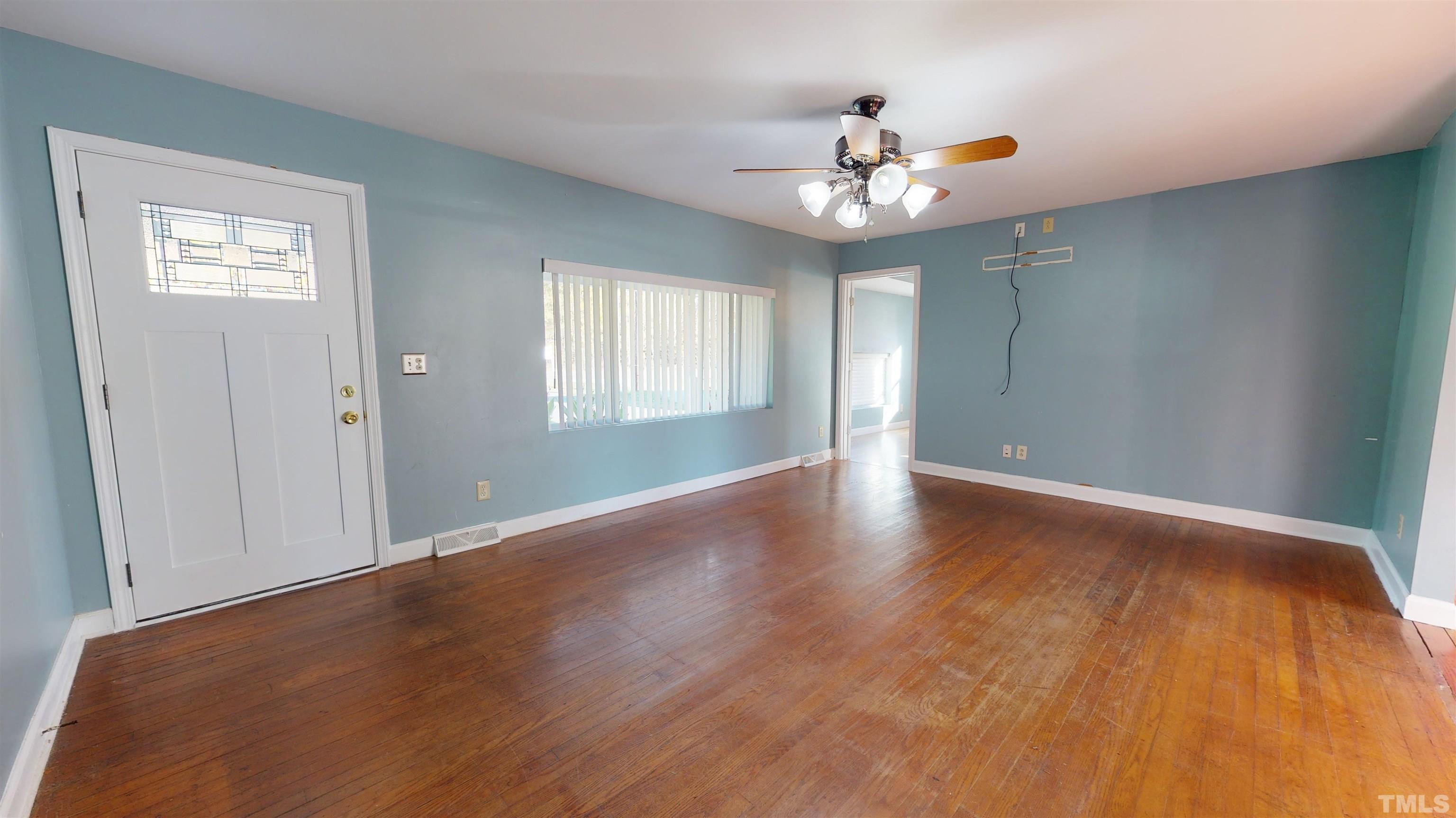 1306 Old Durham Road Roxboro, NC 27573 - Photo 10 of 28 a view of an empty room with wooden floor and a window