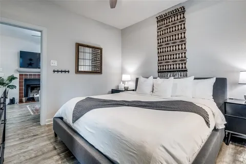 a bedroom with bed and a flat screen tv