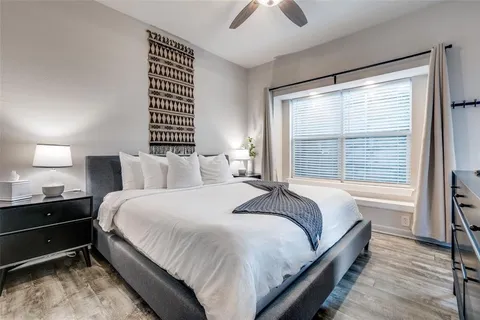 a bed room with a bed and a large window