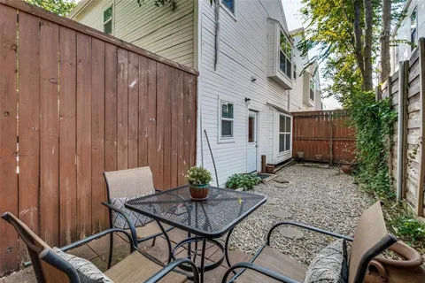 a view of backyard with furniture and a potted plant