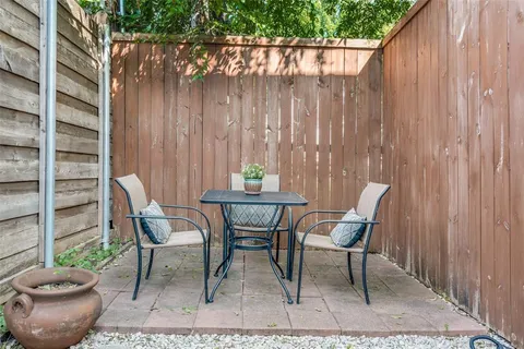 a view of a chairs and table in backyard