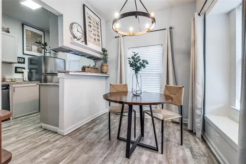 a dining room with wooden floor and breakfast area
