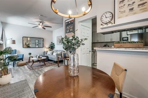 a living room with furniture a chandelier and a mirror