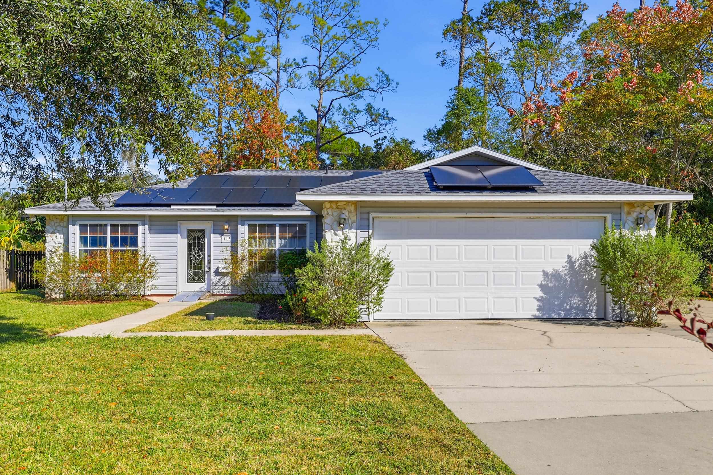 115 Segovia Road St. Augustine, FL 32086 - Photo 1 of 48 a front view of a house with garden