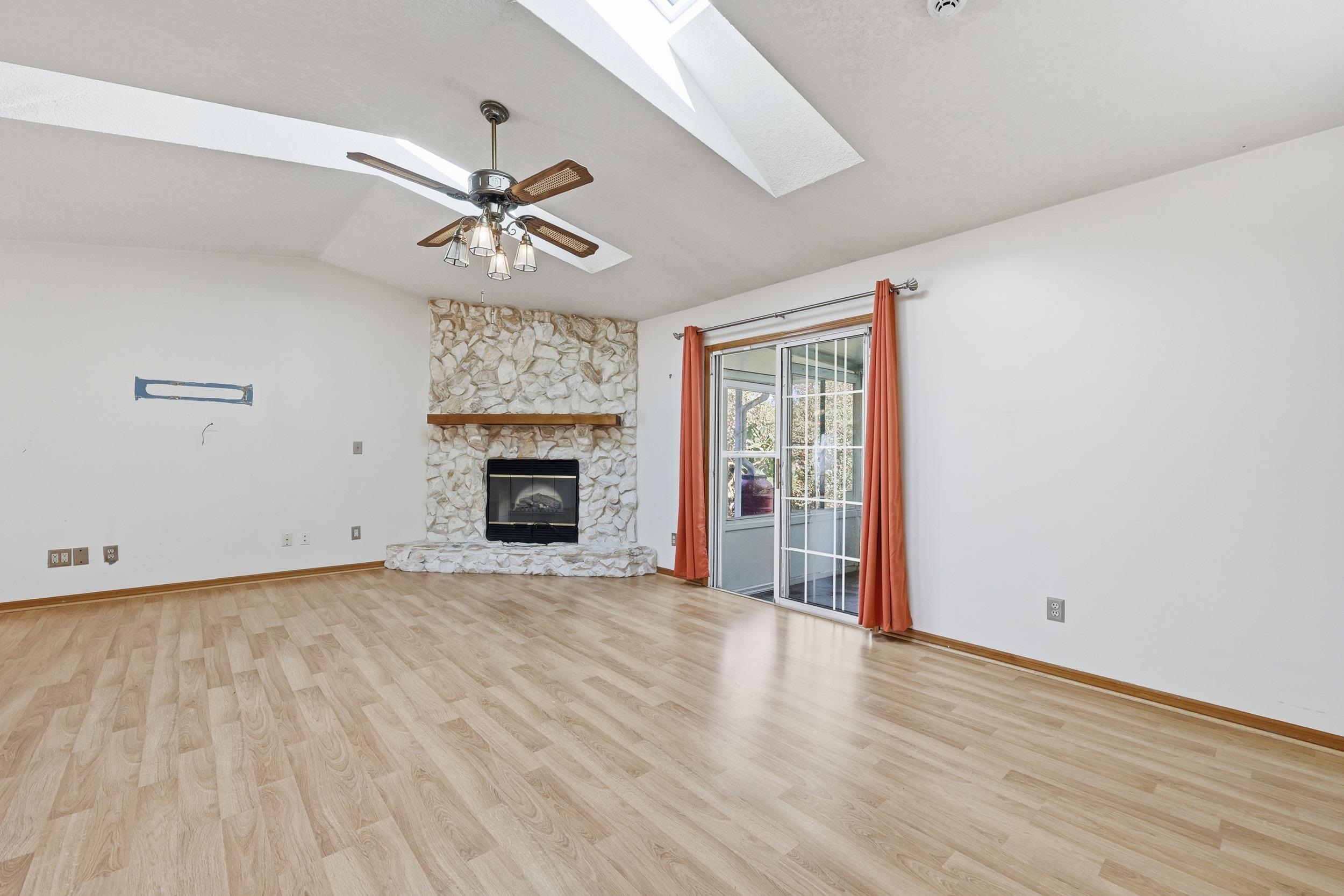 115 Segovia Road St. Augustine, FL 32086 - Photo 11 of 48 an empty room with windows fireplace and a ceiling fan