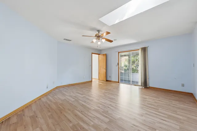 wooden floor in an empty room with a window