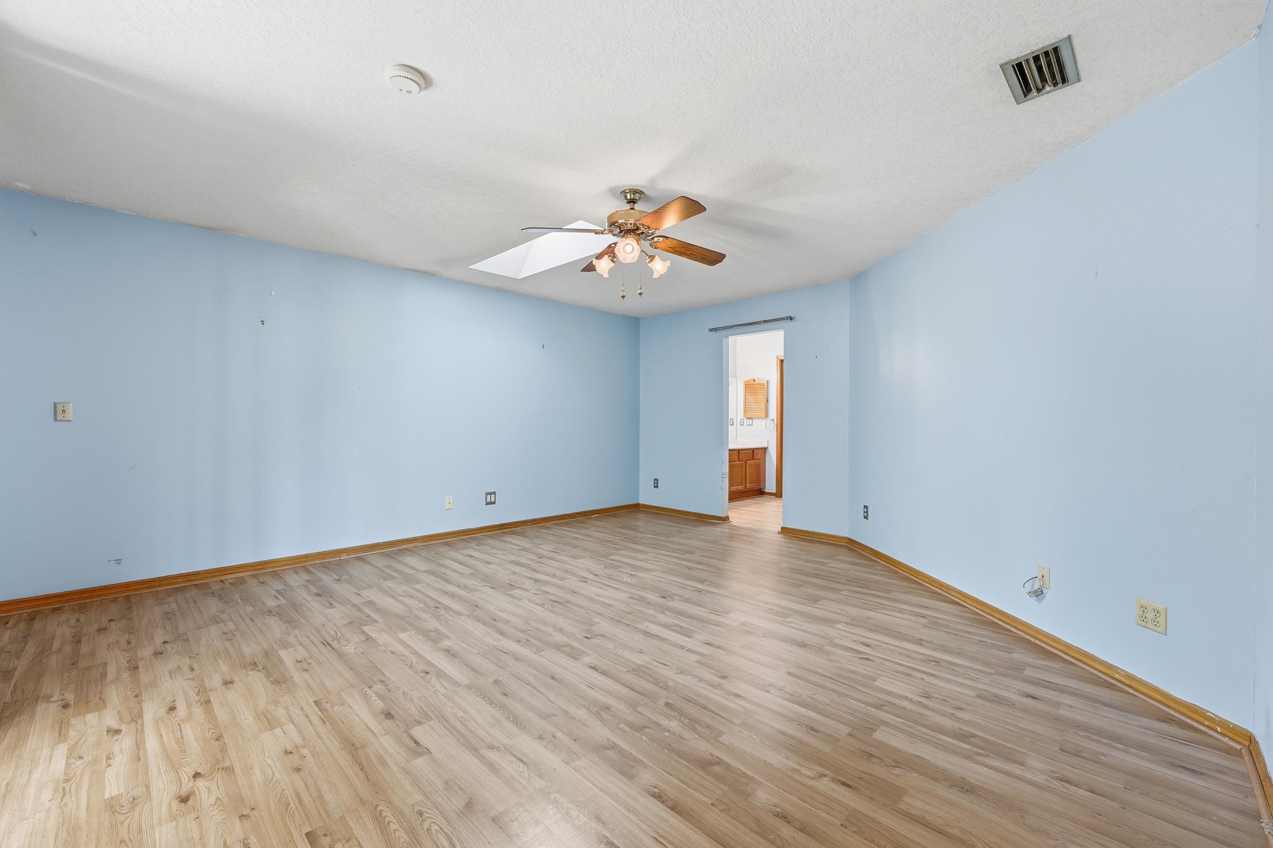115 Segovia Road St. Augustine, FL 32086 - Photo 20 of 48 Spare room with a skylight, light wood-style floors, ceiling fan, and a textured ceiling