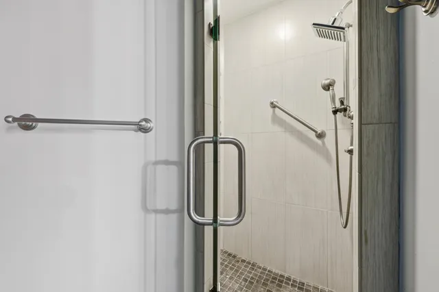 a bathroom with a glass shower door