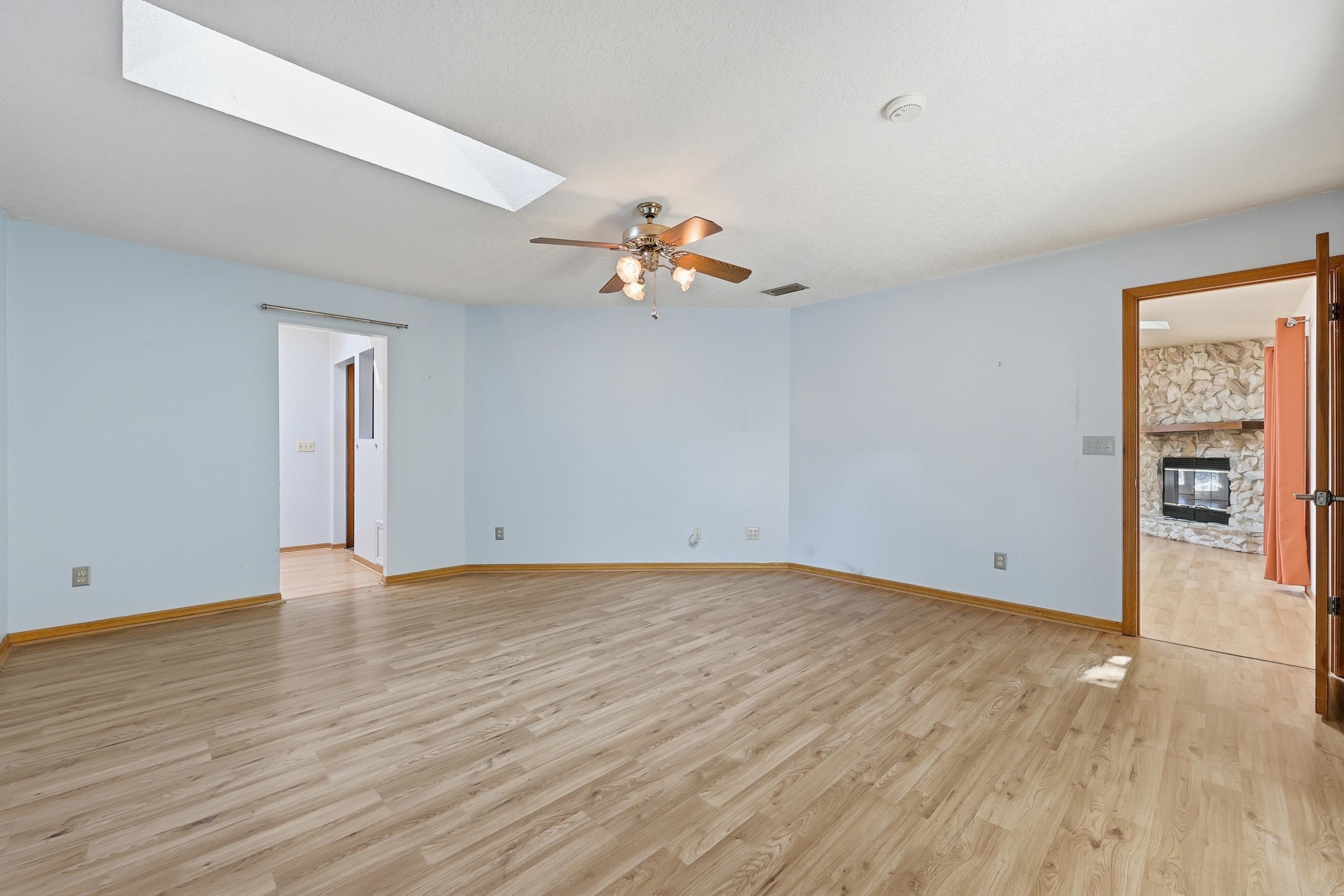 115 Segovia Road St. Augustine, FL 32086 - Photo 23 of 48 an empty room with wooden floor chandelier fan and windows