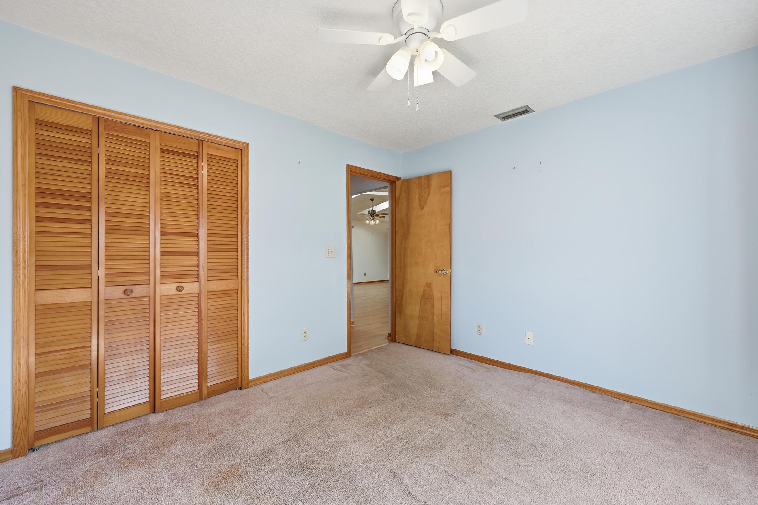 115 Segovia Road St. Augustine, FL 32086 - Photo 28 of 48 Unfurnished bedroom with carpet, a closet, and a ceiling fan