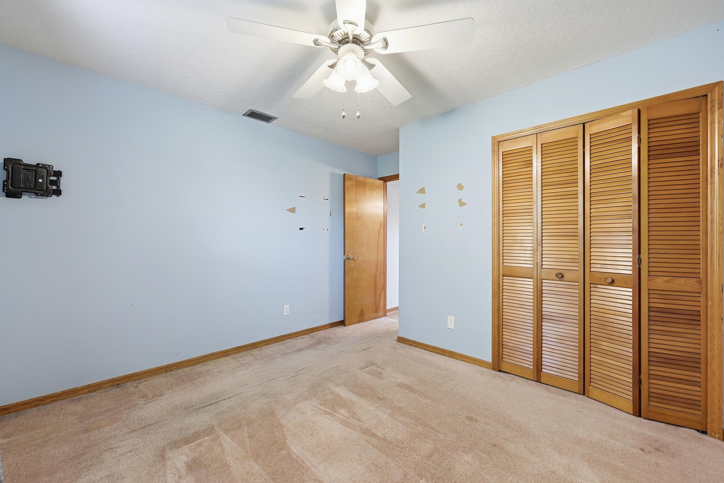 115 Segovia Road St. Augustine, FL 32086 - Photo 31 of 48 Unfurnished bedroom with carpet flooring, a closet, and a ceiling fan