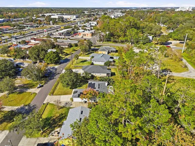 an aerial view of a house with a yard