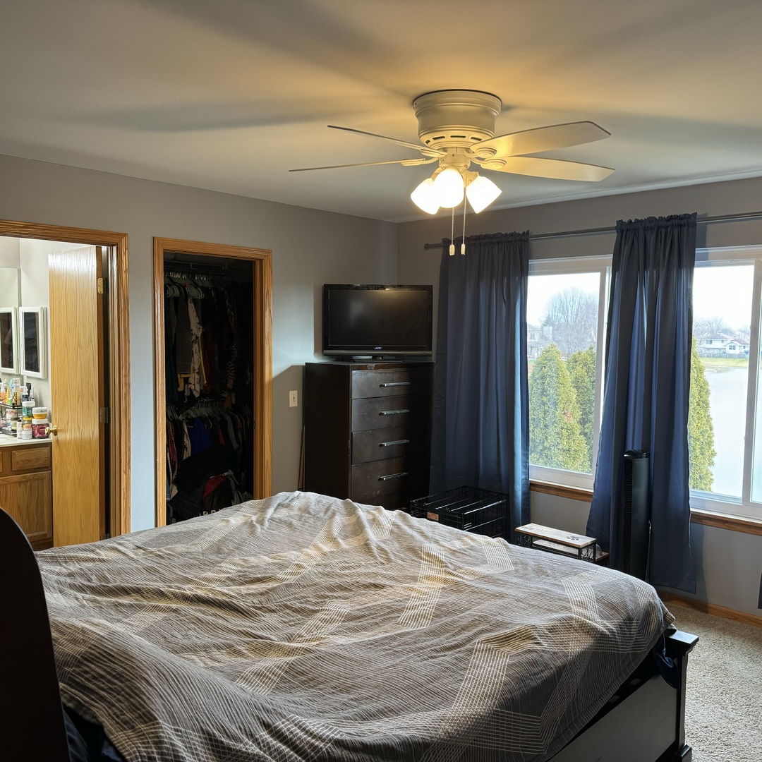 2614 Discovery Drive Plainfield, IL 60586 - Photo 16 of 28 a bedroom with a bed and a flat tv screen next to a window