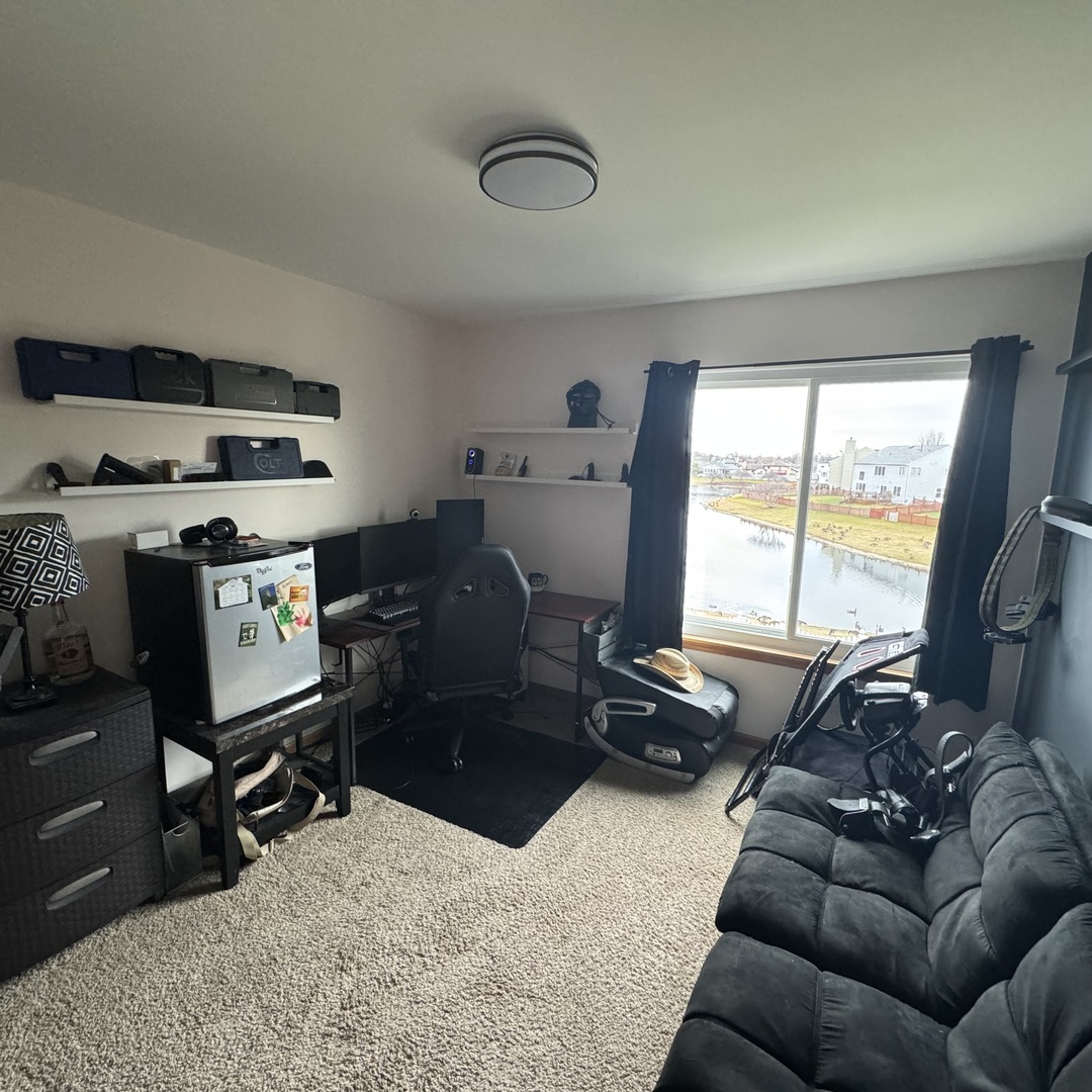 2614 Discovery Drive Plainfield, IL 60586 - Photo 20 of 28 a living room with furniture gym equipment and a large window