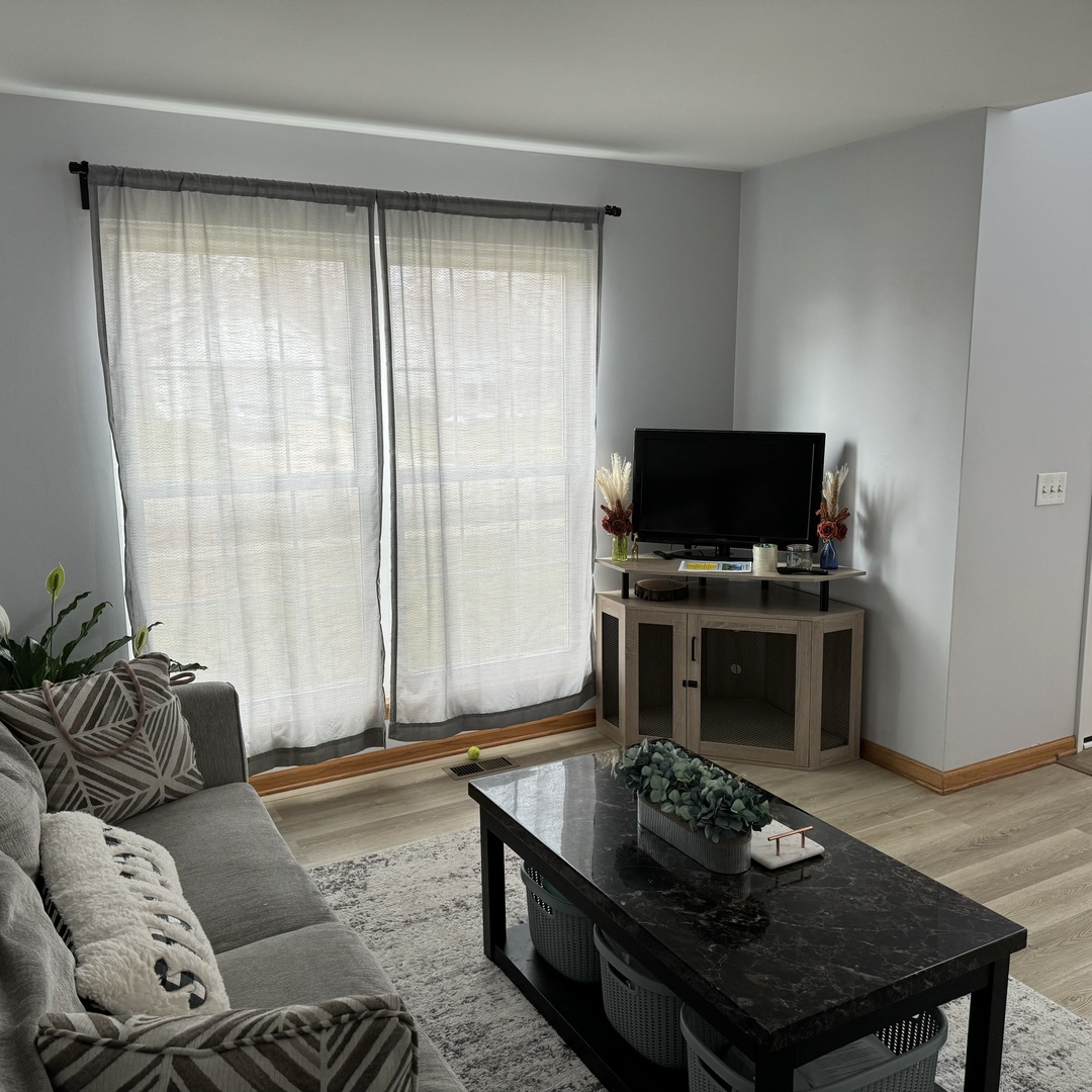 2614 Discovery Drive Plainfield, IL 60586 - Photo 3 of 28 a living room with furniture and a flat screen tv