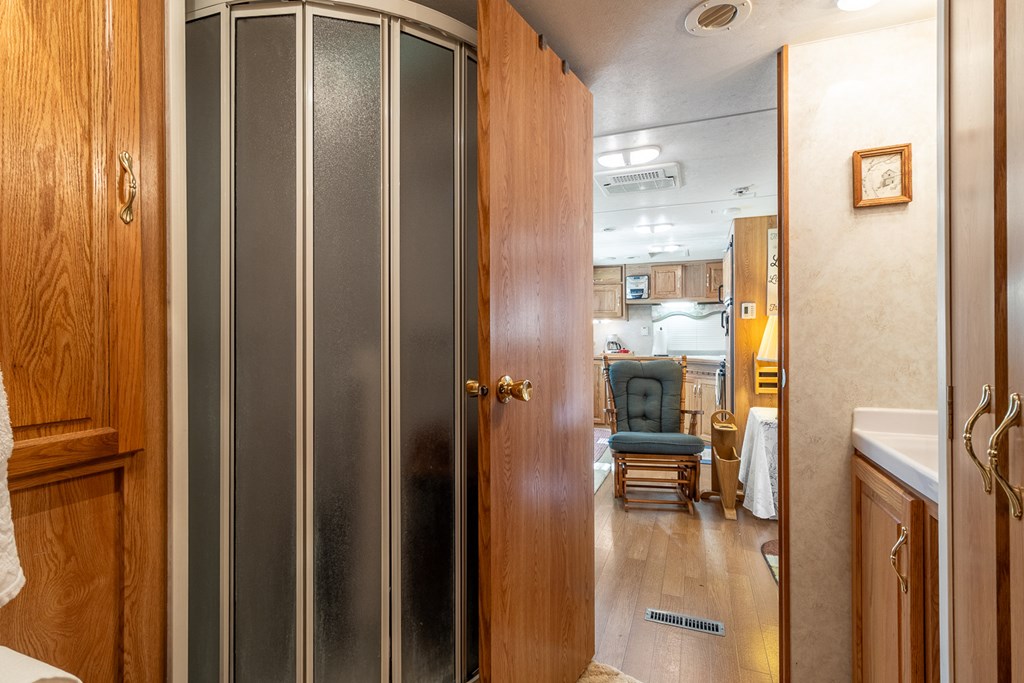 66-186 Peaceful Loop Chatsworth, GA 30705 - Photo 9 of 31 a view of a hallway with wooden floor a living room and dining room