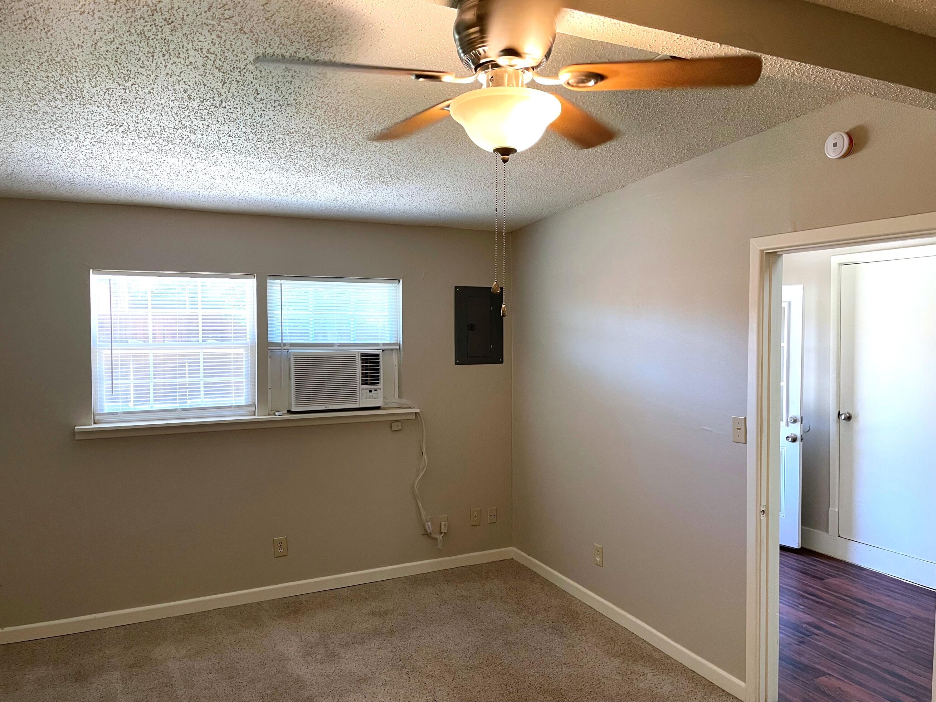 2409 Utica Avenue Lubbock, TX 79407 - Photo 18 of 22 wooden floor in an empty room with a window