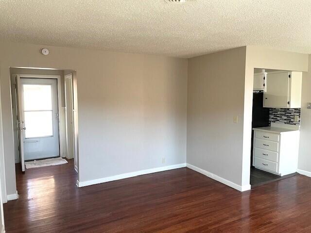 2409 Utica Avenue Lubbock, TX 79407 - Photo 4 of 22 a view of a kitchen with wooden floor