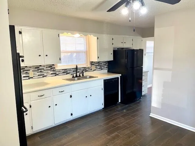a kitchen with white cabinets and appliances