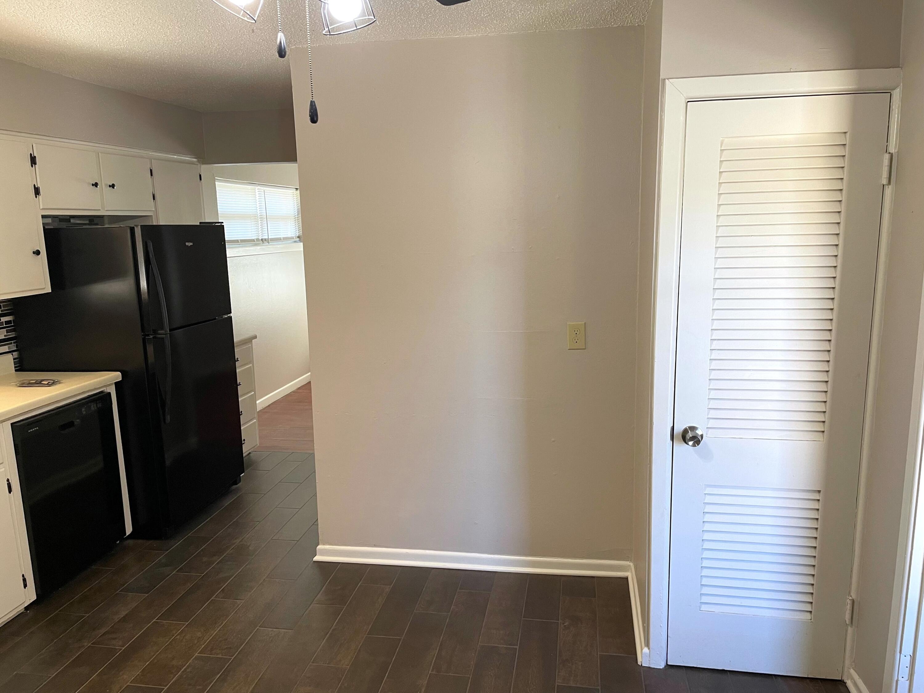 2409 Utica Avenue Lubbock, TX 79407 - Photo 9 of 22 a view of cabinets with wooden floor and electronic appliances