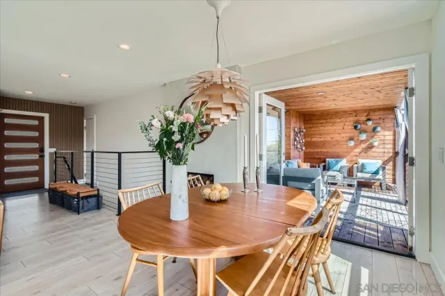 a dining room with furniture and wooden floor