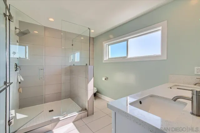 a bathroom with a double vanity sink and a mirror