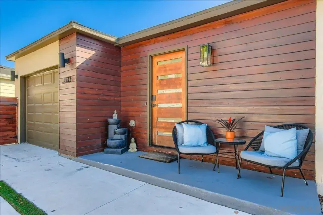 a backyard of a house with table and chairs