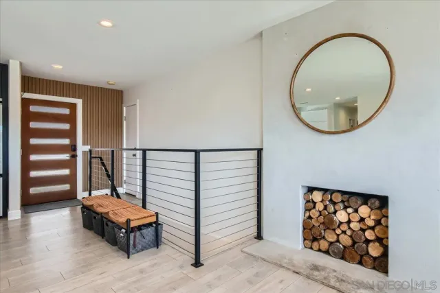 an entryway with wooden floor and window