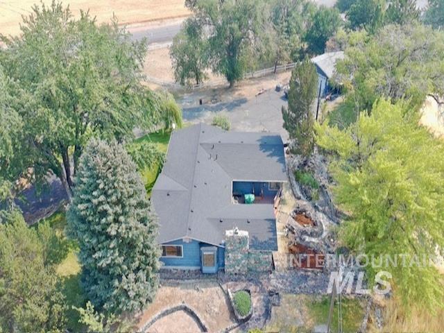 1549 Cove Road Weiser, ID 83672 - Photo 2 of 38 Single-story residence featuring a dark shingle roof and blue exterior siding