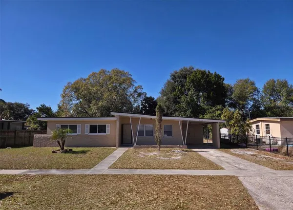a view of a yard with a house in the background