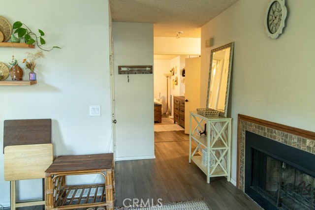 600 Central, Unit 374 Riverside, CA 92507 - Photo 11 of 23 a hallway with wooden floor windows and a fireplace