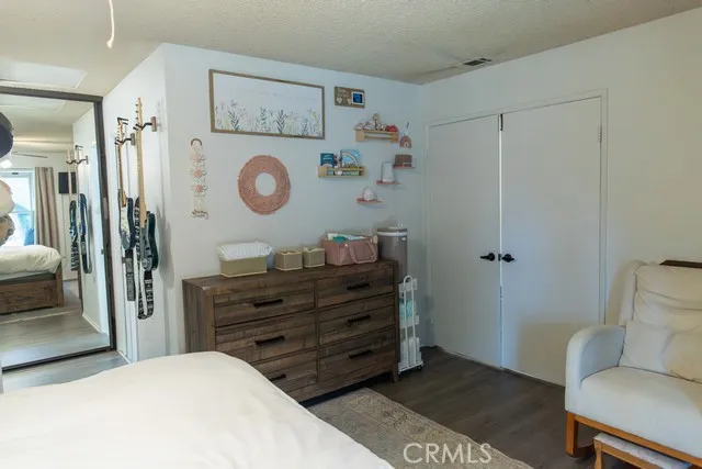 a bedroom with a baby bed mirror and a couch