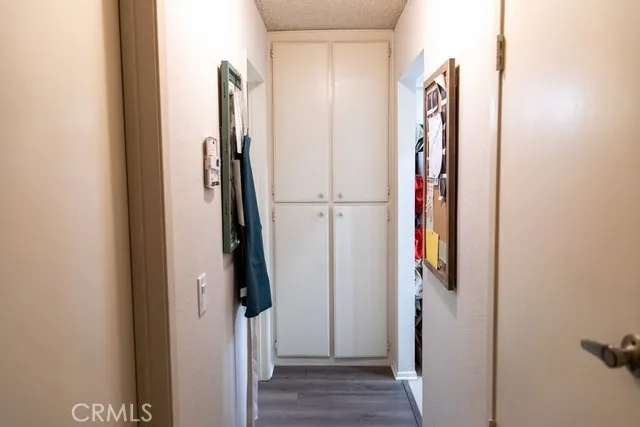 a view of closet with wooden floor
