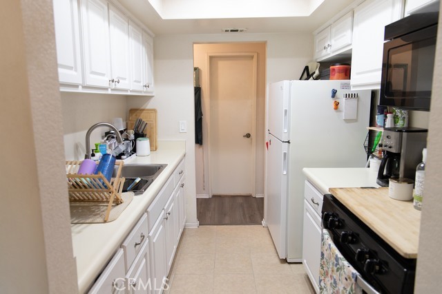 600 Central, Unit 374 Riverside, CA 92507 - Photo 10 of 23 a kitchen with a sink stove and refrigerator