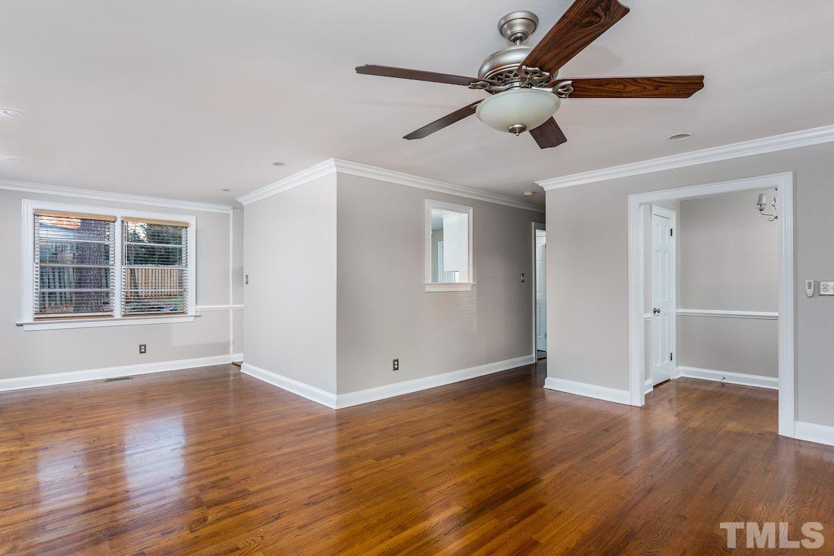 307 Acorn Street Raleigh, NC 27604 - Photo 2 of 24 a view of an empty room with wooden floor and a window
