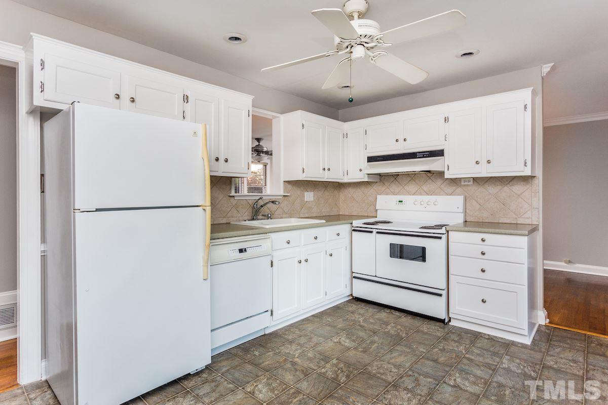 307 Acorn Street Raleigh, NC 27604 - Photo 11 of 24 a kitchen with cabinets stainless steel appliances and a window