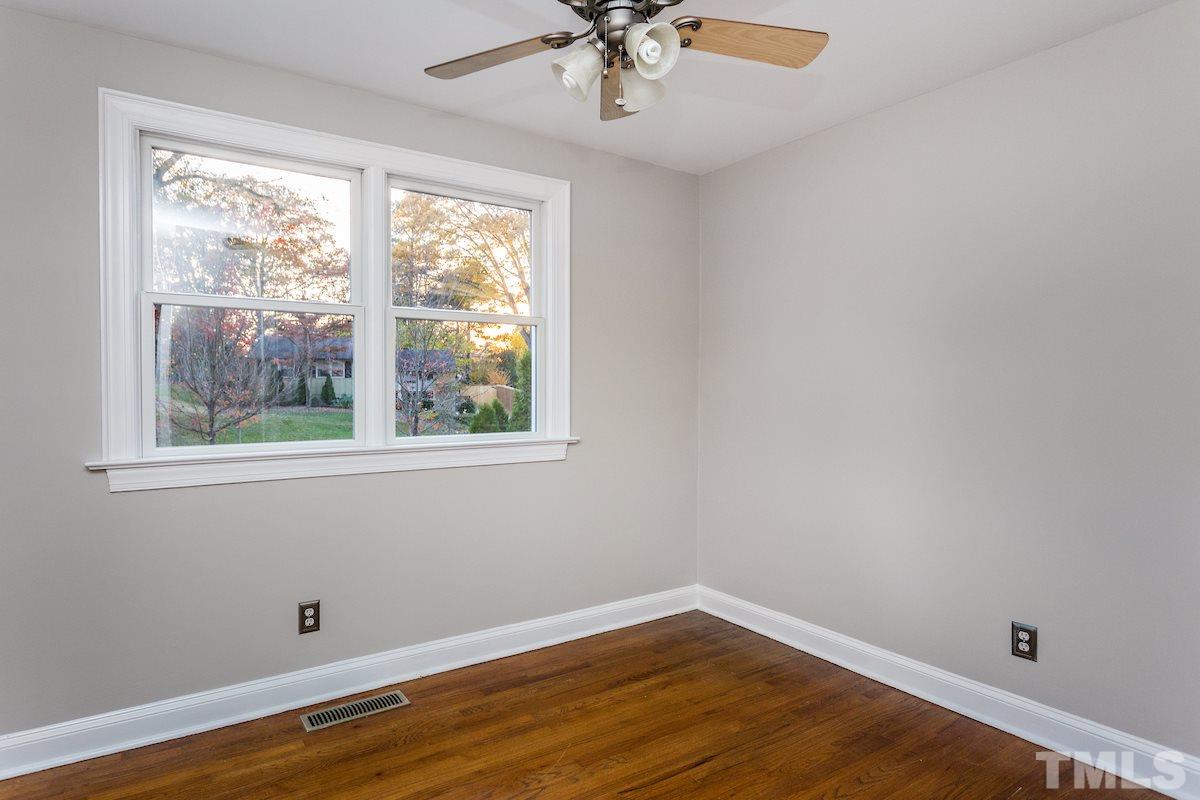 307 Acorn Street Raleigh, NC 27604 - Photo 14 of 24 a view of an empty room with wooden floor and a window