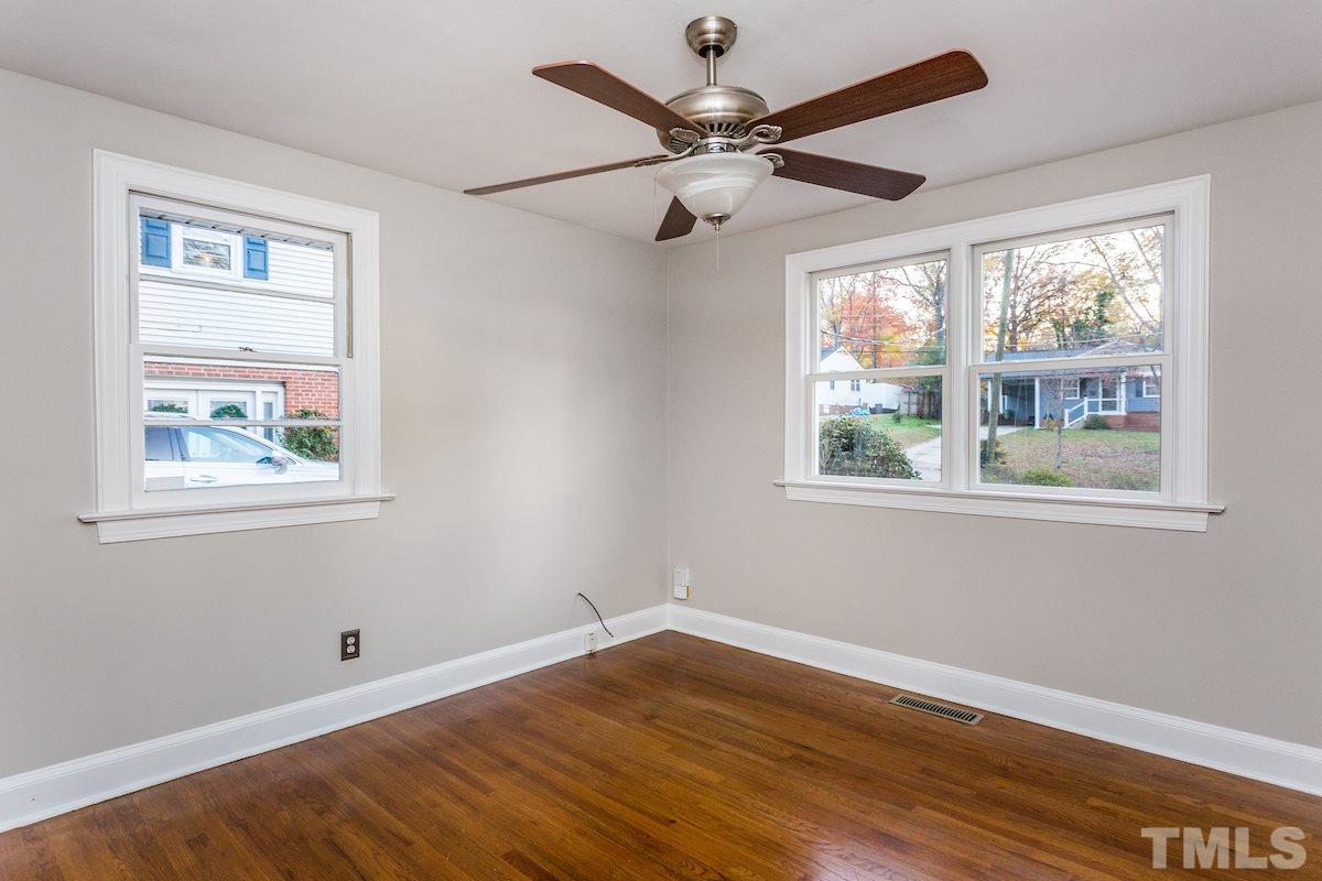 307 Acorn Street Raleigh, NC 27604 - Photo 15 of 24 a view of an empty room with wooden floor and a window