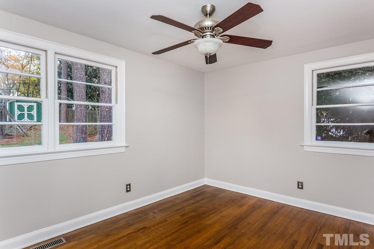 307 Acorn Street Raleigh, NC 27604 - Photo 16 of 24 an empty room with wooden floor closet and windows