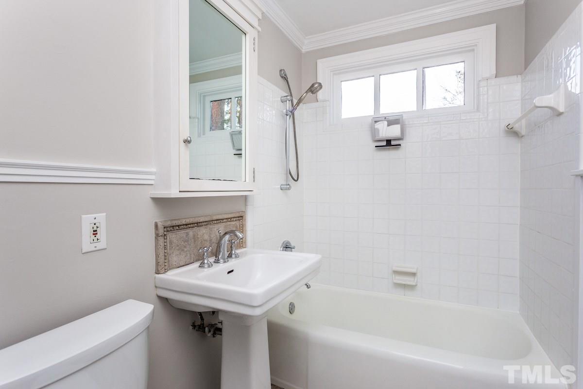 307 Acorn Street Raleigh, NC 27604 - Photo 17 of 24 a bathroom with a sink a toilet and shower